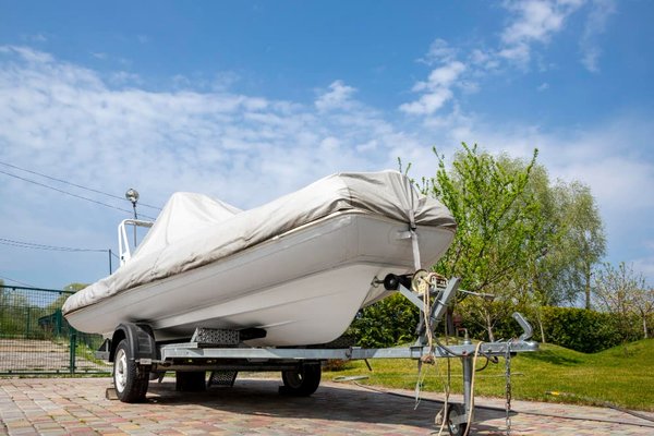 Boat covered and parked on its trailer