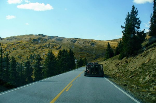 Highway running through a high mountain meadow