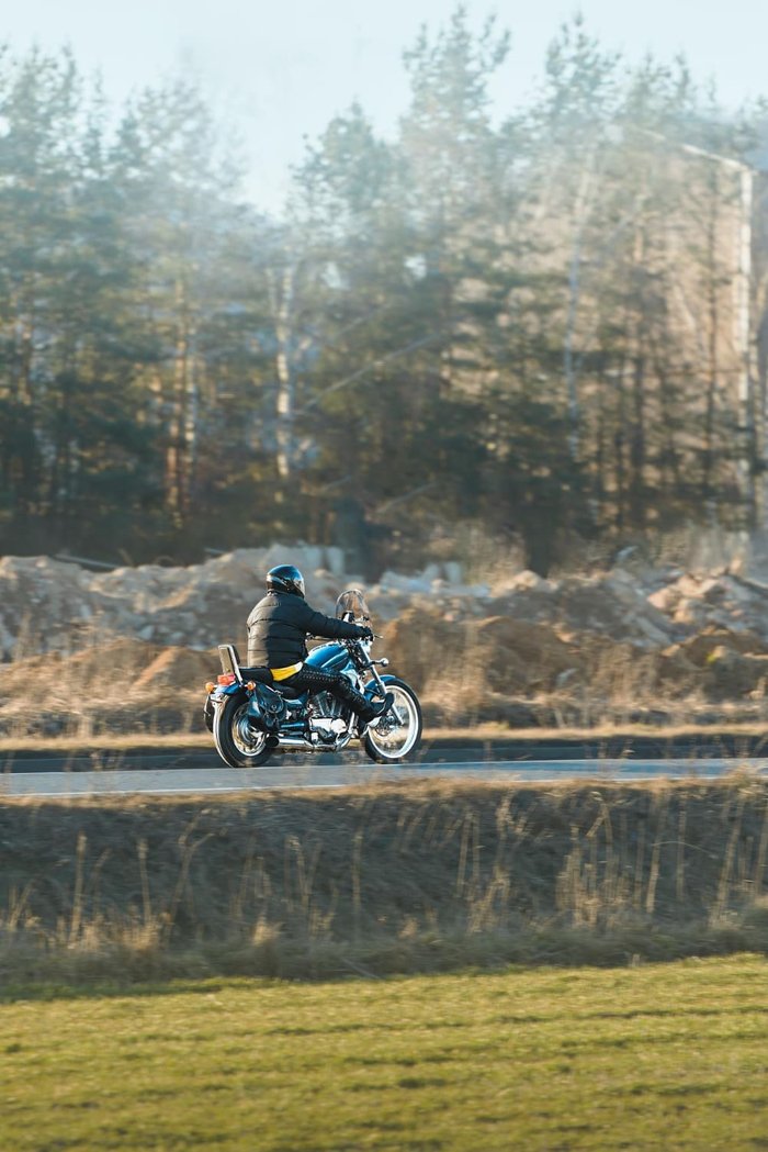 Rider on a cruiser motorcycle on a wet mountain road