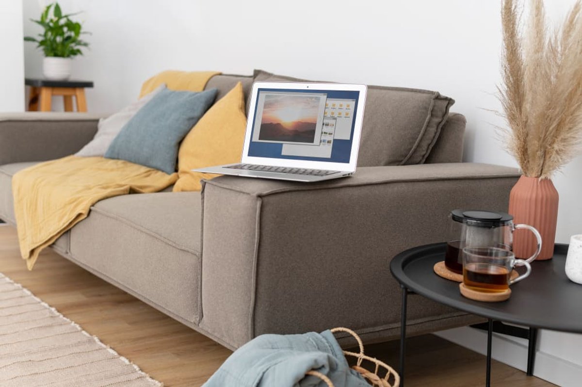 A laptop and personal belongings in a rented living room