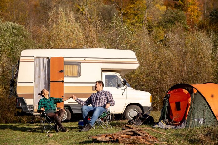 Couple camping with their RV in autumn